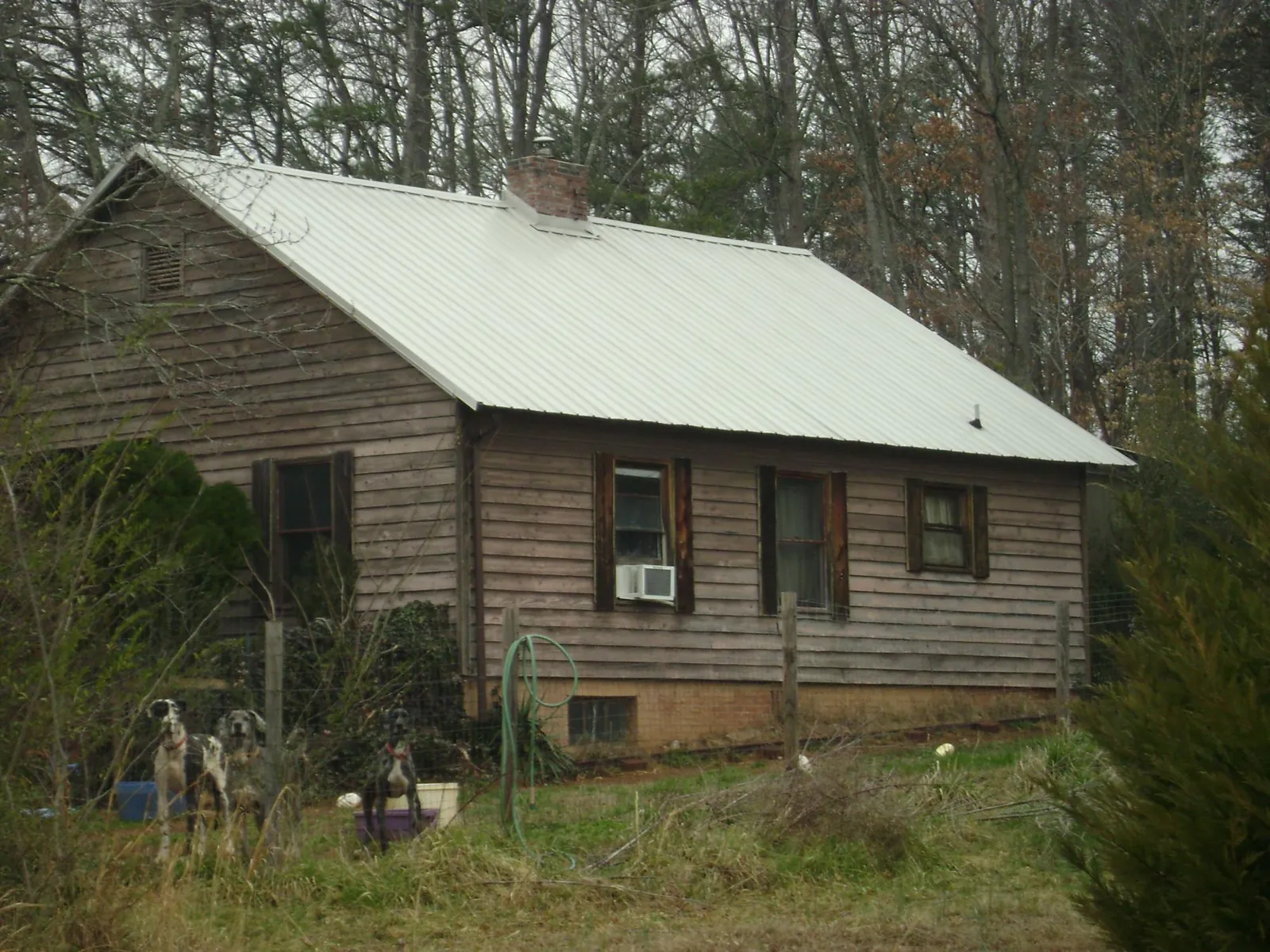White metal roof on an old wood sided farmhouse, from a Metal Roof Installation job in Nekoma